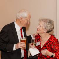 Two holiday reception guests looking at each otherWoma